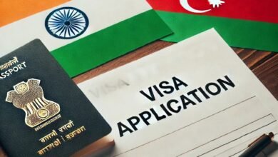 Indian passport, Azerbaijan and India flags, and a visa application form with a pen.