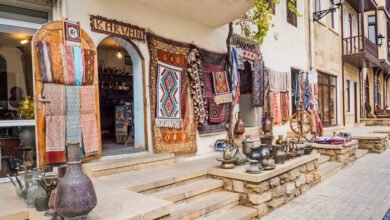 Traditional Azerbaijani shop in Baku displaying vibrant carpets and unique antiques, famous for shopping.