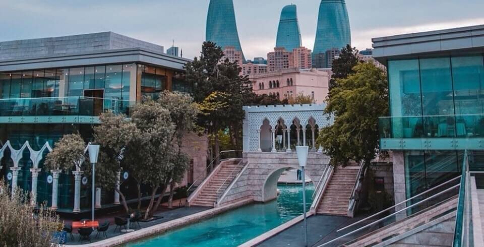 A vibrant view of modern Baku, showcasing sleek skyscrapers, the iconic Flame Towers